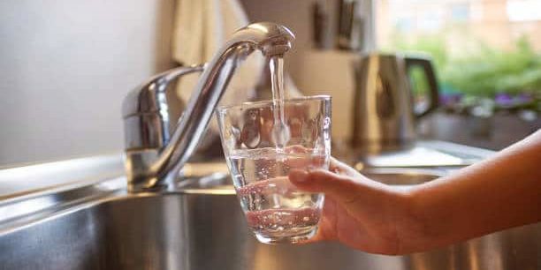 Pouring Fresh Tap Water Into a Glass